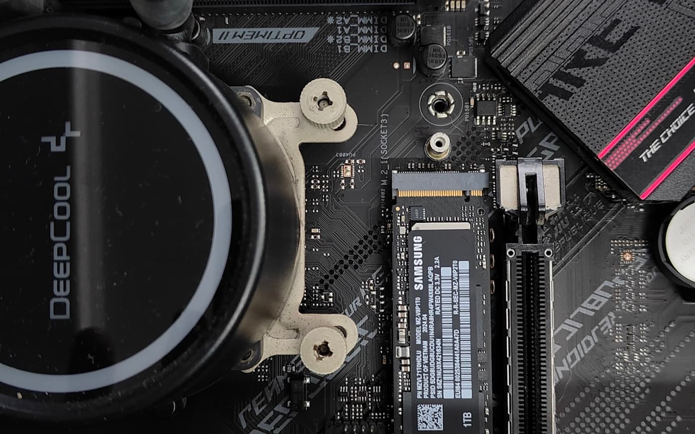 A motherboard shot close, cooler block and expansion slots lit from one side.